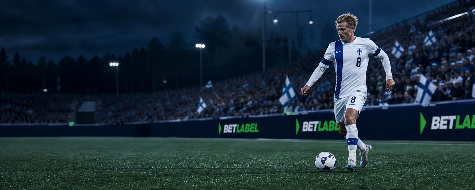 Adult football players attacking in a Finnish stadium